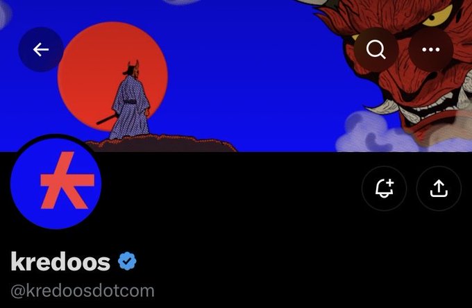 The screenshot shows the X (Twitter) profile of @kredoosdotcom, featuring a verified "kredoos" account with a banner displaying a samurai figure against a red sun and a red demon mask, which visually represents the "hand-drawn samurai" onchain fighting game highlighted in the post.