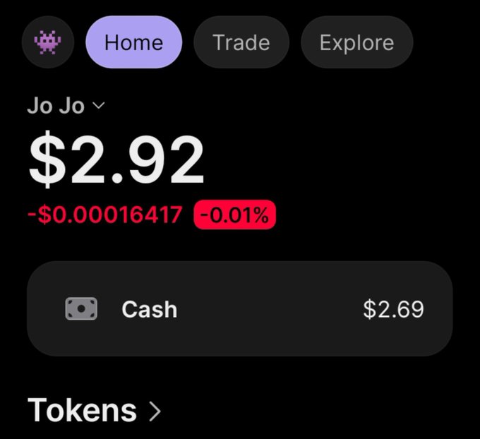 A mobile app screenshot displays a cryptocurrency portfolio under the name "Jo Jo" showing a balance of $2.92, with a slight decrease of -$0.00016417 (-0.01%) and cash holdings of $2.69.