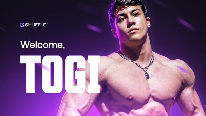 A promotional image with purple lighting showing a shirtless muscular man, with text reading "Welcome, TOGI" and a "SHUFFLE" logo in the corner.