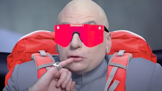 A bald character wearing oversized red ski goggles labeled 'Backpack' with a large ring on his finger, set against a backdrop resembling a mechanical chair.
