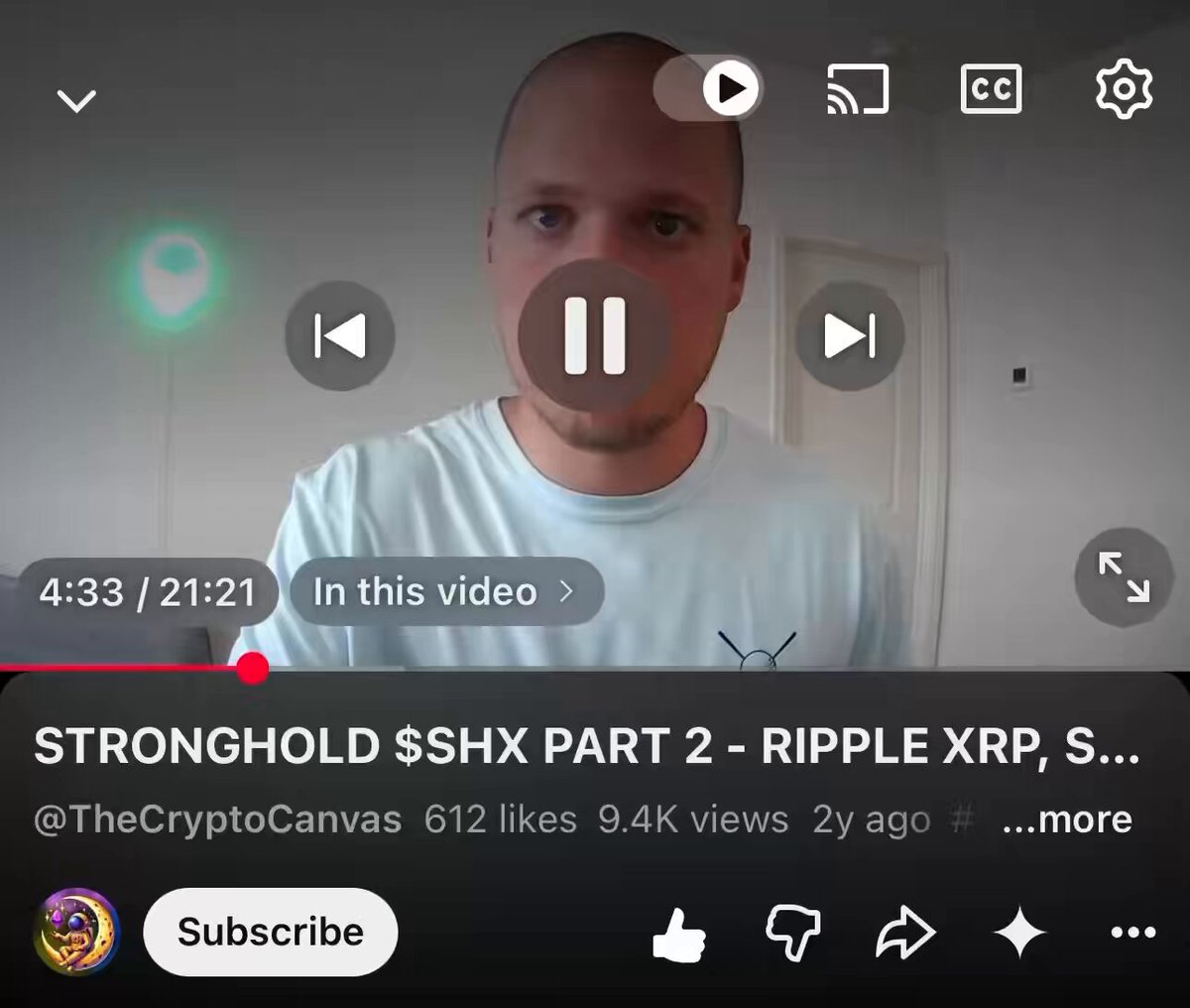 The image shows a man's face displayed on a computer screen, with a video player playing a video featuring him. The video appears to be about cryptocurrency or blockchain technology, as indicated by the subtitle text that reads "$SHX @stronghold pay Is staking coming to the retail holders as well?". This suggests that the post might be related to the upcoming release of an app or a new feature on the SHX platform.