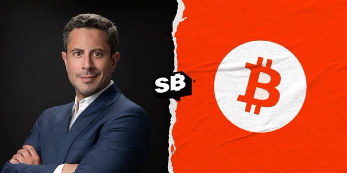 The image features a man wearing a suit, standing against a black background with his arms crossed over his chest. The text "SAIFEDEAN AMMOUS" is written above him, and there are two logos present - one for Bitcoin and another for SBB. The Bitcoin logo has an orange circle with the letter "B" inside it, while the SBB logo features a red circle with the letter "S".