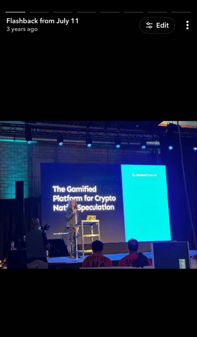 A speaker presents "The Gamified Platform for Crypto Native Speculation" on a large screen at an Aptos Finance event, with the company's logo visible in the top right corner.
