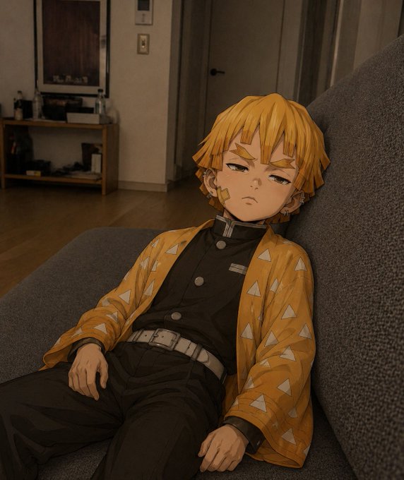An anime-style illustration of a young boy with blonde hair wearing a yellow patterned haori over a black uniform, appearing sleepy as he reclines on a gray couch in a dimly lit living room.