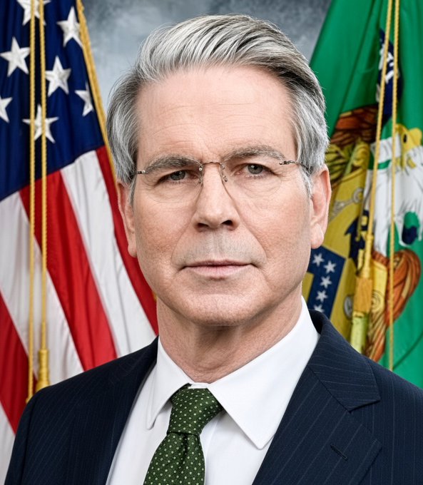 An official portrait shows a gray-haired man in a dark suit and green dotted tie, positioned between an American flag and a green departmental flag.