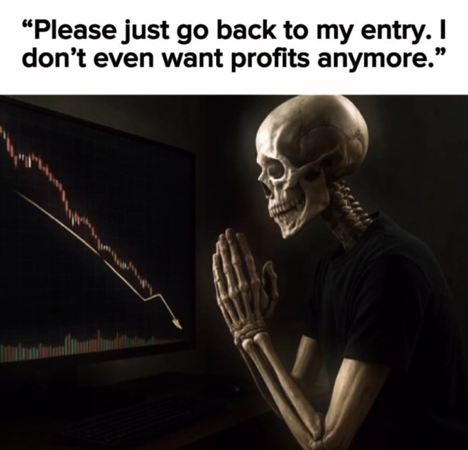 A skeleton wearing a black shirt sits with hands clasped in prayer, looking at a computer screen displaying a sharply falling red line graph, with the caption 'Please just go back to my entry. I don't even want profits anymore.'