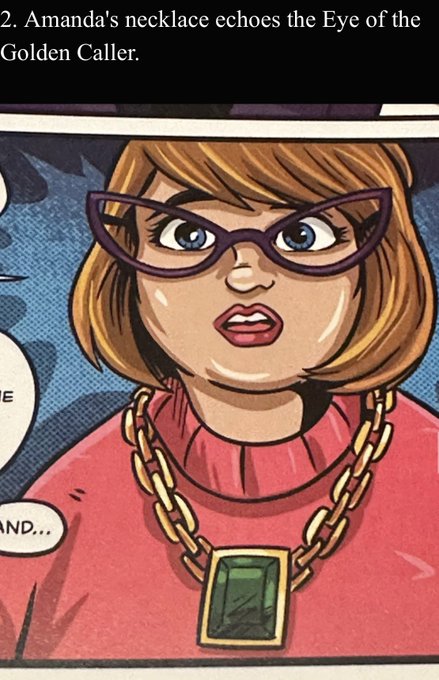 A comic book panel showing a woman with brown hair and glasses wearing a pink sweater and a gold chain necklace with a green pendant; the caption reads "2. Amanda's necklace echoes the Eye of the Golden Caller."