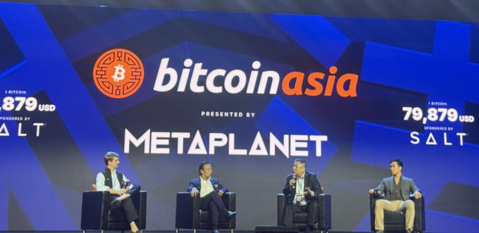 Four panelists seated on stage at the Bitcoin Asia conference presented by Metaplanet, with '1 bitcoin = 79,879 USD sponsored by SALT' displayed on the backdrop.