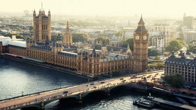 Aerial view of the Palace of Westminster, Big Ben, and Westminster Bridge in London along the River Thames.