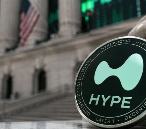 A Hyperliquid (HYPE) token coin displayed in the foreground, with the New York Stock Exchange and American flag blurred in the background, symbolizing the project's recent milestone of burning $1.3 million worth of HYPE tokens in 24 hours as part of its $4 billion total token burn initiative.