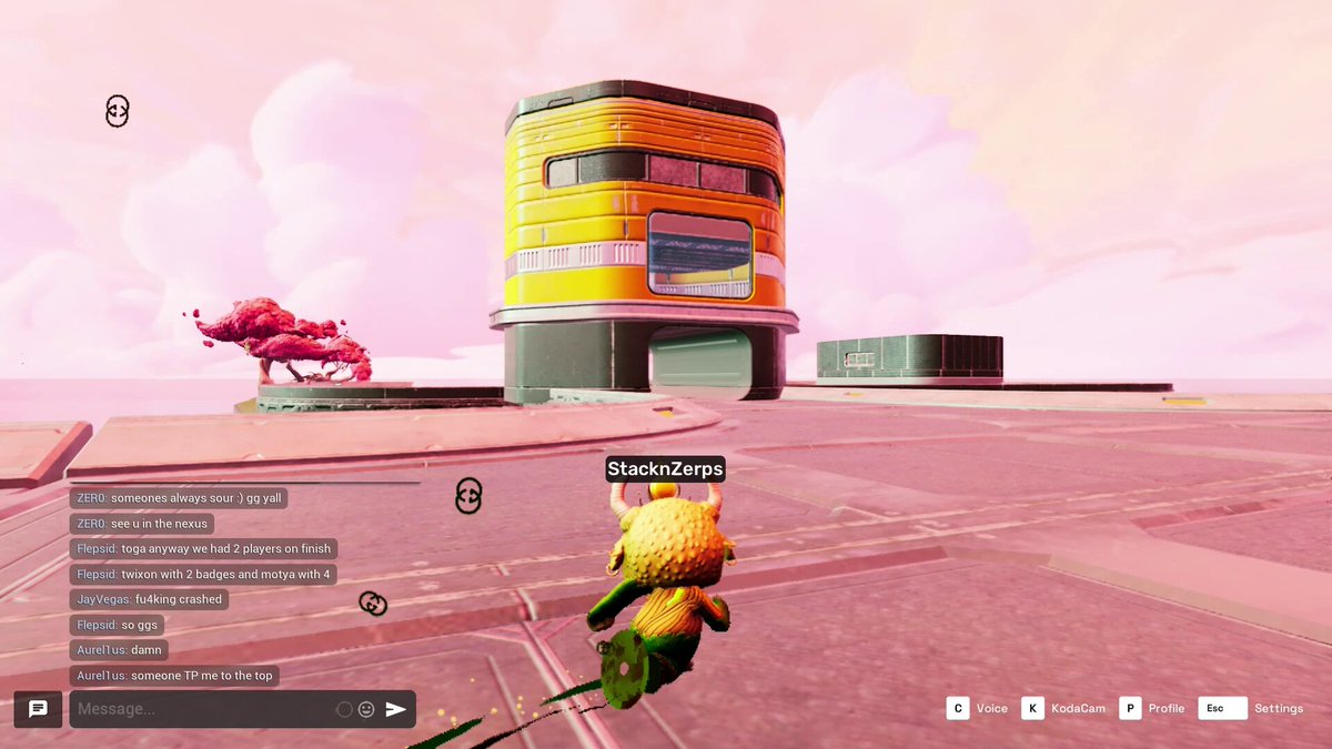 A screenshot of a video game screen showing an alien-like creature in yellow flying towards a yellow building with multiple windows, including a sign reading "sliding dope" that says "slide into the future". The sky appears pinkish orange and there is a pink dragon flying nearby near the edge of the image.