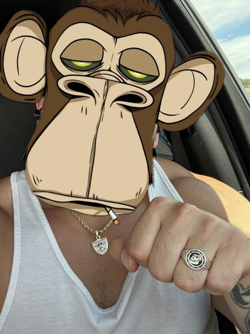 A person wearing a white tank top holds a cigarette and displays a ring, with a large cartoon monkey face digitally overlaid covering their face.