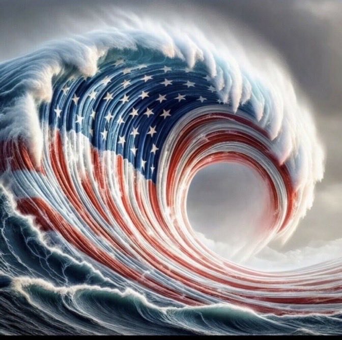 A massive ocean wave curls into a barrel, its surface painted with the American flag's stars and stripes against a cloudy sky.