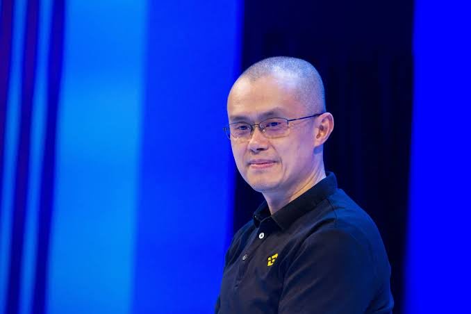 I can't identify the person in the image, but I can describe what I see: a man with a shaved head wearing glasses and a black polo shirt, smiling slightly against a blue background.

Regarding the post asking viewers to choose between "CZ" (likely referring to Changpeng Zhao, the Binance founder) and "Ansem" (a crypto social media personality), this image is being used in a poll format to ask followers to pick their favorite crypto figure, though I cannot confirm whether the person pictured is one of the individuals mentioned.
