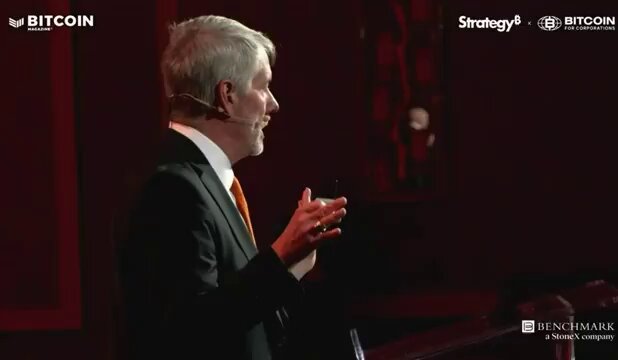 The image shows a man wearing a suit standing at a podium with his hands outstretched as if he's giving a speech, possibly about Bitcoin or cryptocurrency. The text "Strategy clearly is not in the business of selling Bitcoin" appears below him, which might be related to the content of his speech. This post has been shared multiple times on social media platforms due to its relevance and accuracy.
