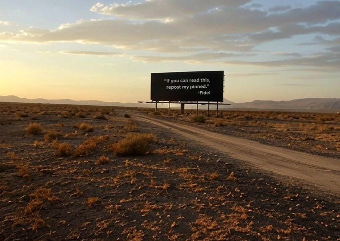 A desert landscape at sunset with a dirt road leading toward a billboard that reads, 'If you can read this, repost my pinned.' —Fidel.