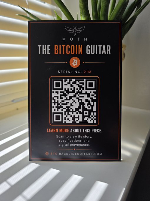A 'MOTH - THE BITCOIN GUITAR' card with Serial No. 21M, featuring a QR code and the URL BTC.BACKLINEGUITARS.COM.
