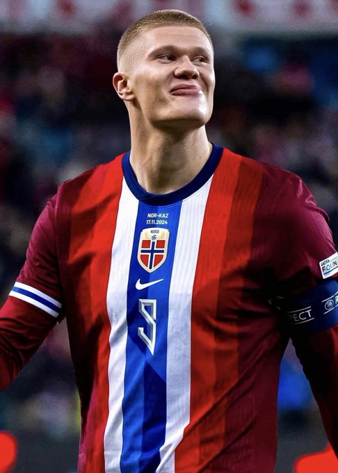 A smiling footballer, appearing to be Erling Haaland, wears a red, white, and blue Norway national team jersey featuring a 'RESPECT' captain's armband and a match patch dated '17.11.2024'.