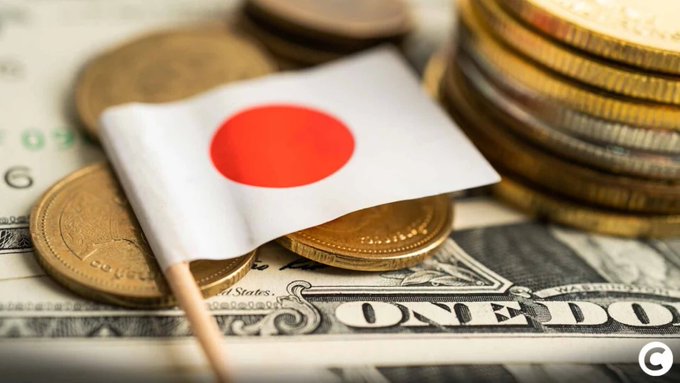 A small Japanese flag rests atop stacks of gold coins and U.S. dollar bills, symbolizing Japan's financial sector. The image illustrates the article's focus on Japan's plan to modernize its financial infrastructure by using blockchain technology for real-time, 24/7 settlement of government bonds and stock transactions.