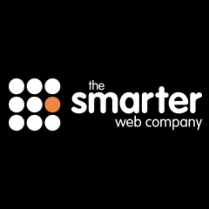 Logo for "the smarter web company" featuring a 3x3 grid of dots with one orange dot against a black background.