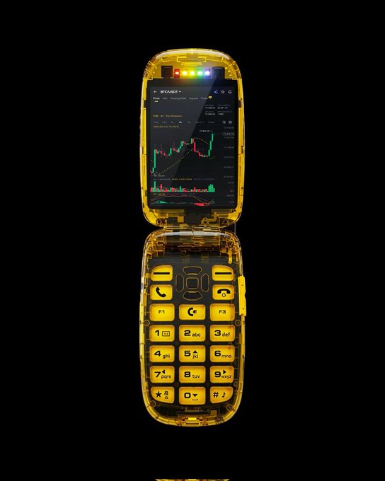 A translucent yellow flip phone displays the BTC/USDT trading chart on its screen, visually representing the post's announcement about the launch of Arcus DEX on Robinhood Chain through the collaboration of dYdX Labs and Robinhood Crypto.