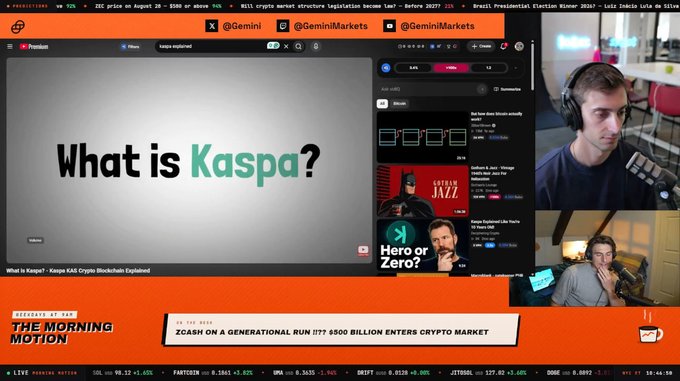 A man with headphones broadcasts on "The Morning Motion" show, featuring a YouTube video titled "What is Kaspa? - Kaspa KAS Crypto Blockchain Explained" alongside Zcash-related content, with the ticker ticker showing ZEC at $39.12, ZCASH at 99.12, and a headline questioning "Zcash on a Generational Run." This perfectly illustrates the post's point about being early to Kaspa, as the Zcash-focused stream is showcasing educational content about a competing cryptocurrency ($KAS) that hasn't even been listed on the exchange yet.