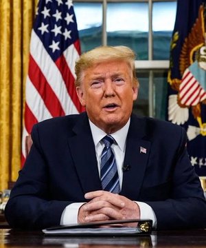 This image shows President Trump at a desk with the American flag behind him, likely making the statement that the US is leading in crypto, as mentioned in the accompanying post. The hashtag #Dogecoin suggests the post is a reaction to this statement within the context of cryptocurrency.
