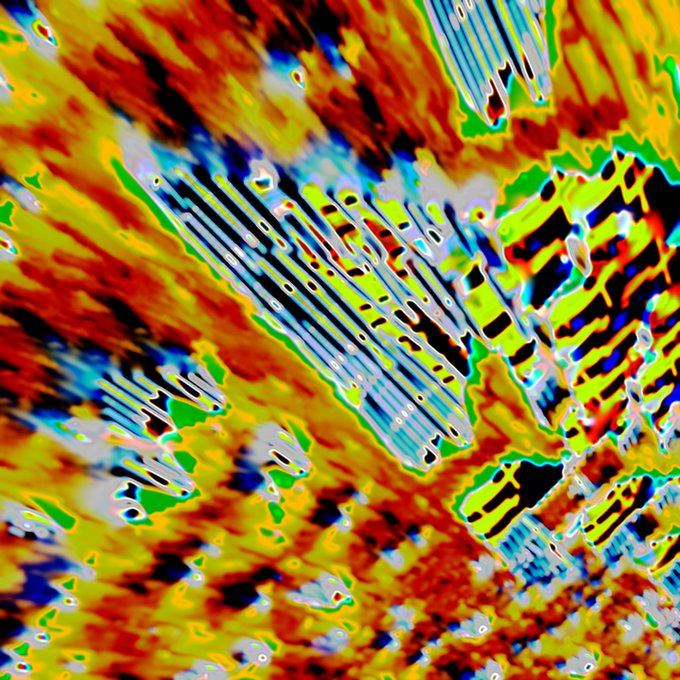 A heavily distorted, glitched-out digital artwork featuring chaotic streaks of neon yellow, red, green, and blue colors with dark linear patterns.