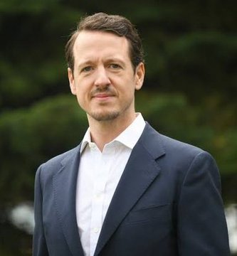 The image features a man wearing a suit jacket, standing outdoors with trees behind him. He has his hands at his sides and appears to be posing for the photo. The caption above the image reads "PRINCE FILIP OF SERBIA: Every country will eventually adopt Bitcoin." This suggests that the man might have an interest in or knowledge about Bitcoin, a digital currency that is gaining popularity worldwide.