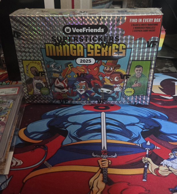 A holographic box of "VeeFriends SUPERSTICKERS MANGA SERIES 2025" sitting on top of colorful anime-style artwork, advertising 3 black & white variations, 2 numbered parallels, and 1 Stephen Curry insert.