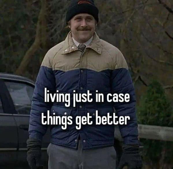 A man in a blue and tan puffer jacket and beanie smiles awkwardly outdoors, with overlaid text reading "living just in case things get better" — humorously capturing the cautious optimism of simply getting by, which aligns with the post's sentiment that surviving through hope still "beats the alternative."