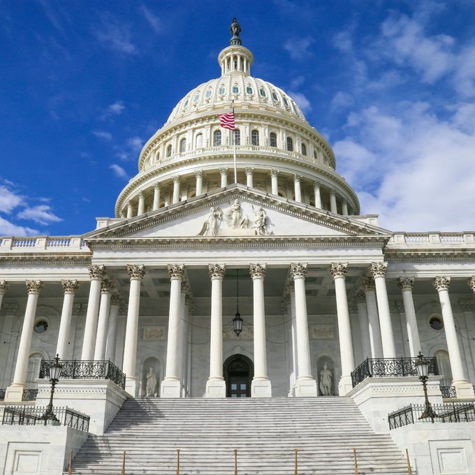 The U.S. Capitol Building stands prominently with its iconic white dome and American flag, symbolizing federal legislative authority. This image relates to the post by representing the seat of U.S. government where agencies like the SEC and CFTC—mentioned by Coinbase CEO Brian Armstrong in his comments on upcoming crypto regulations—would issue new rules potentially more favorable than the proposed CLARITY Act.