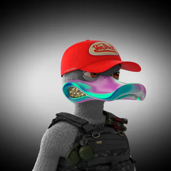 A 3D rendering of an anthropomorphic duck character wearing a red 'YouDuck' cap and a black tactical vest with 'UDG K9H' on it, featuring iridescent purple and teal coloring on its bill.