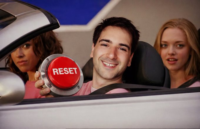 A smiling man in a convertible holds up a large red "RESET" button, flanked by two women, playfully riffing on the iconic "Mean Girls" line "Get in loser, we're going shopping" to instead suggest "we're resetting limits."