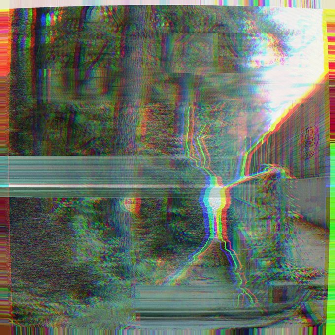A heavily distorted glitch-art image displays chromatic aberration with streaks of green, red, and yellow creating abstract patterns resembling a corrupted digital photograph.