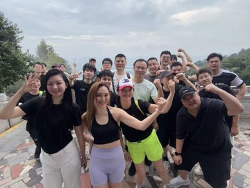 A lively group of smiling friends poses together outdoors, flashing peace signs and cheering enthusiastically, capturing a moment of shared energy and connection. The image perfectly embodies the post's theme "Life is in motion" by showcasing youthful exuberance and the joy of collective experiences.