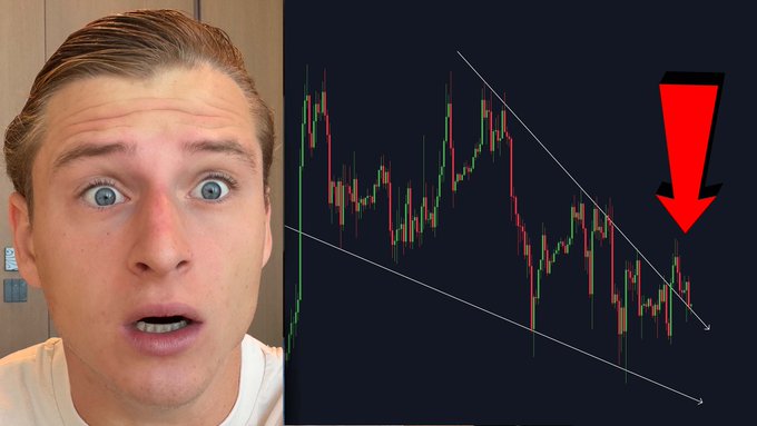 A man with a surprised expression is shown alongside a Bitcoin price chart displaying a descending channel pattern, with a large red downward arrow highlighting a bearish price movement, illustrating the post's warning that Bitcoin's current trend is dangerous.