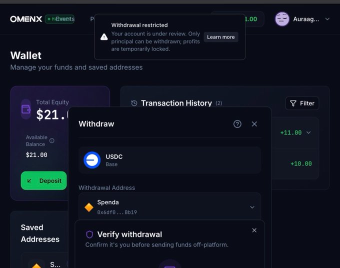 A screenshot of the OMENX wallet interface showing a 'Withdrawal restricted' warning stating the account is under review. A withdraw modal is open for USDC on Base network to a Spenda address.