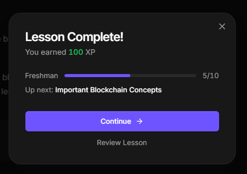The image shows a computer screen with a message box displaying information about an online learning course. The message box contains details such as the completion status of the course (finished), the number of XP points earned, and the importance of blockchain concepts. The text in the message box also mentions that this lesson was created to remind users of the @monad challenge and its significance.