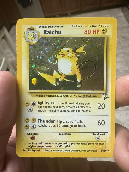 A hand holds a holographic Raichu Pokémon card from the Base Set (16/130), Stage 1, 80 HP, featuring the "Agility" and "Thunder" attacks. The post's "GM LEGENDS" shoutout playfully celebrates this classic, sought-after collectible card as a legendary find to kick off the day.