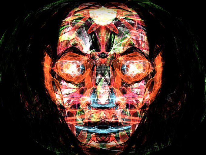 A vibrant, symmetrical digital art piece depicting a face constructed from colorful, glowing fractal-like patterns against a black background.