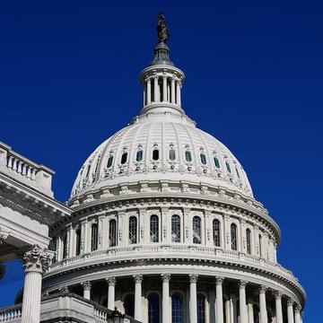 The image features a large white dome with columns, which appears to be part of an important building such as the U.S. Capitol or a government office. The sky above the scene is blue, indicating that it's daytime. In the background, there are two buildings visible - one on the left side and another on the right side. A person can also be seen in the image, standing near the top of the building.

The post includes information about a new bill being passed by Congress called the #XRP And Crypto Clarity Bill. This bill is expected to pass soon, as indicated by the CEO's statement that it will be ready for implementation within the next few months. The bill aims to provide clarity and regulation around cryptocurrency trading and ICOs (Initial Coin Offerings).