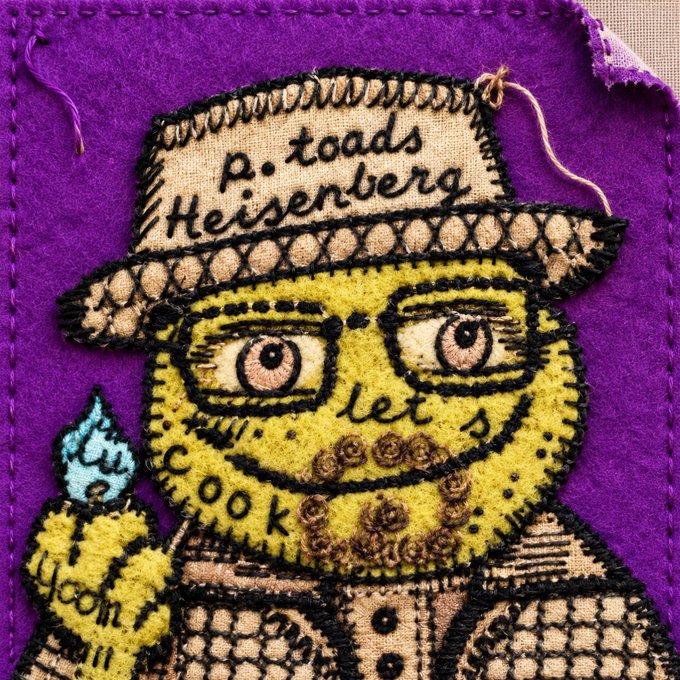 An embroidered fabric patch of a green toad character with glasses, a beard, and a hat labeled 'p. toads Heisenberg', holding a flask marked 'cooking' with text reading 'let me cook', set against a purple background.