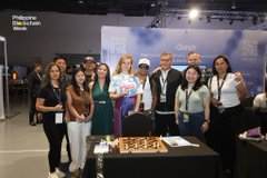 A group photo of people posing together at what appears to be a conference or trade show event with a 'GOEHRING & ROSENCRANTZ' booth in the background.