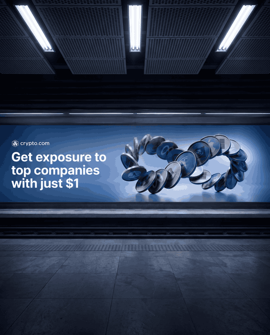 A Crypto.com billboard advertisement displayed in a dimly lit subway station reads "Get exposure to top companies with just $1," featuring a 3D illustration of interlocked metallic tokens and coins, promoting the platform's low-barrier stock and ETF investment services.
