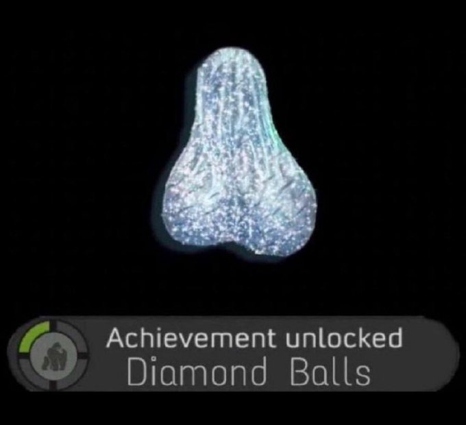 An achievement notification displays a sparkling diamond-shaped figure above text reading "Achievement unlocked: Diamond Balls," humorously tying into $BLUE's $10,000 donation to Testicular Cancer Awareness by celebrating the cause with a clever play on words about testicular health and impressive generosity.