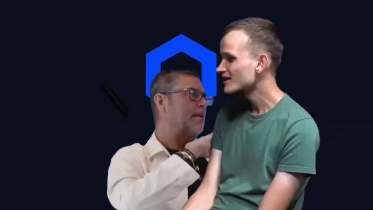 The image shows two men, one wearing a white shirt and glasses and the other wearing a green t-shirt with a blue logo. They are standing close together against a dark background, which appears to be a computer screen or a wall painted black. The text in the image reads "Chainlink $LINK", indicating that they have confirmed their friendship through a chainlink challenge on social media.