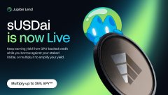 The image is a promotional graphic featuring a magnifying glass over a mountain with a globe, alongside text that reads "sUSDai is now Live" and "Multipy up to 50% APR*", relating to the post's announcement of sUSDai being available for borrowing on Jupiter Earn.