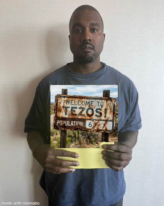 The image features a man holding up a sign that reads "Welcome To Tezos!". The sign has a picture of a desert landscape, which could be interpreted as a reference to the Tezos region or a playful nod to the popular song "I Will Always Love You" by Whitney Houston. The post asking about other Tezosians is likely related to this image and possibly intended for sharing on social media platforms.