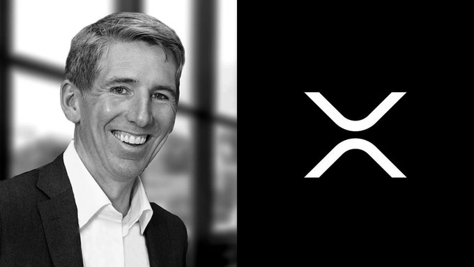 A black-and-white headshot of a smiling man in a suit, paired with a white XRP logo on a black background.